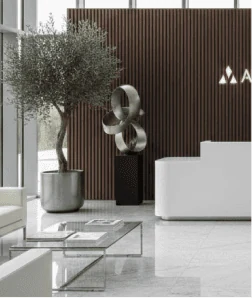 Modern luxury building lobby with an olive tree, sculpture and reception desk