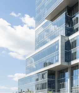Modern glass high-rise building against a blue sky