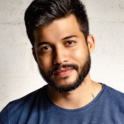 Portrait of a man with a beard in a navy t-shirt