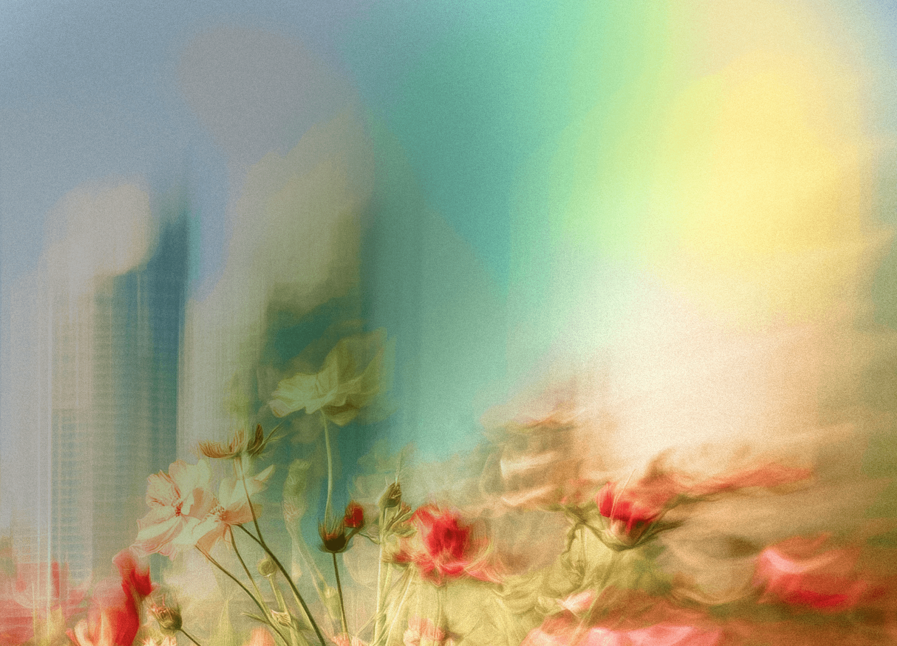 Dreamy soft-focus photo of wildflowers blooming in front of city skyscrapers